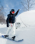 Snowboarder wearing red SFT CLIP goggles beside a deep snowbank